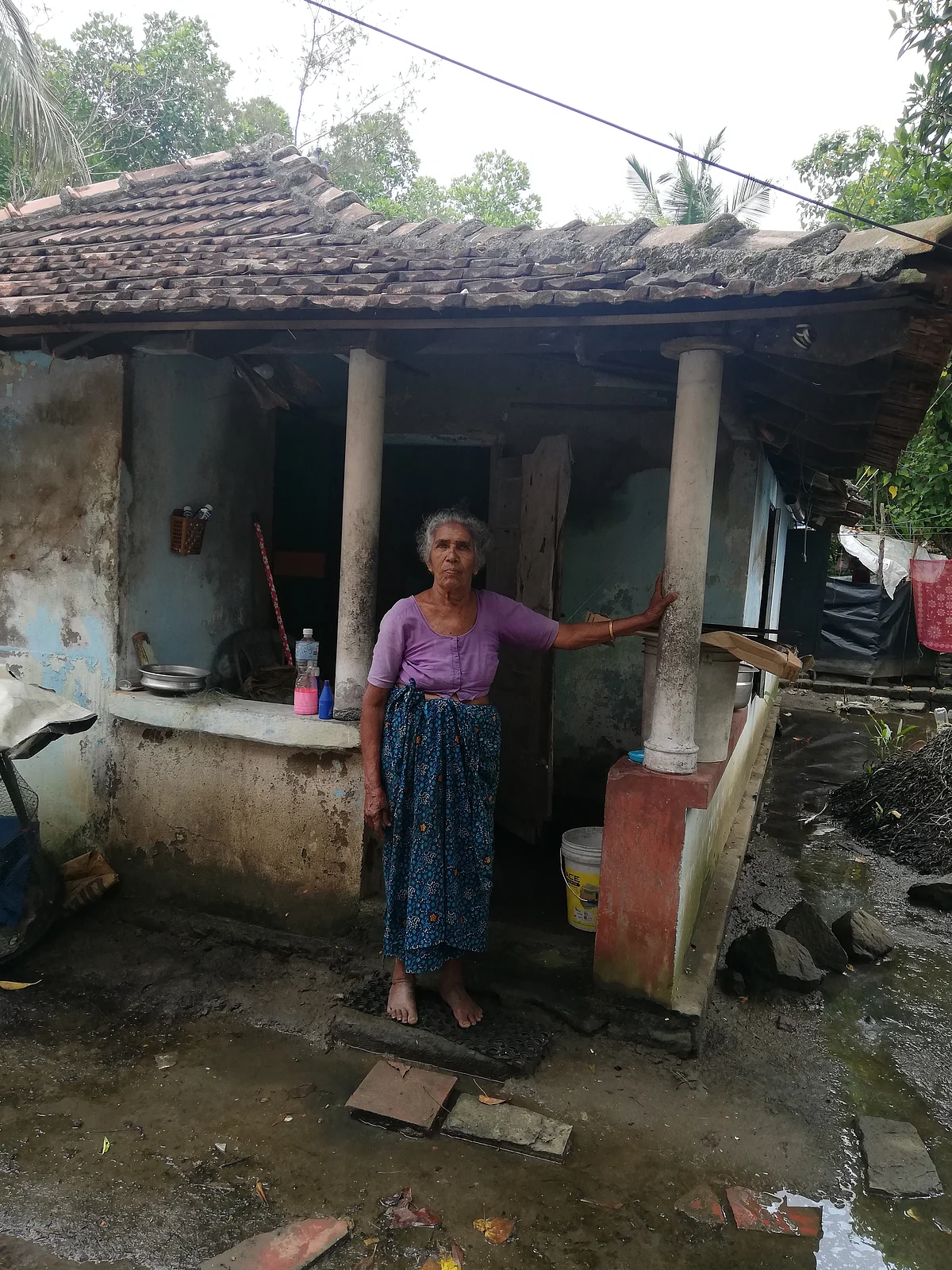 <div class="paragraphs"><p>Padma Rajappan outside her house where the lake water floods everyday.</p></div>
