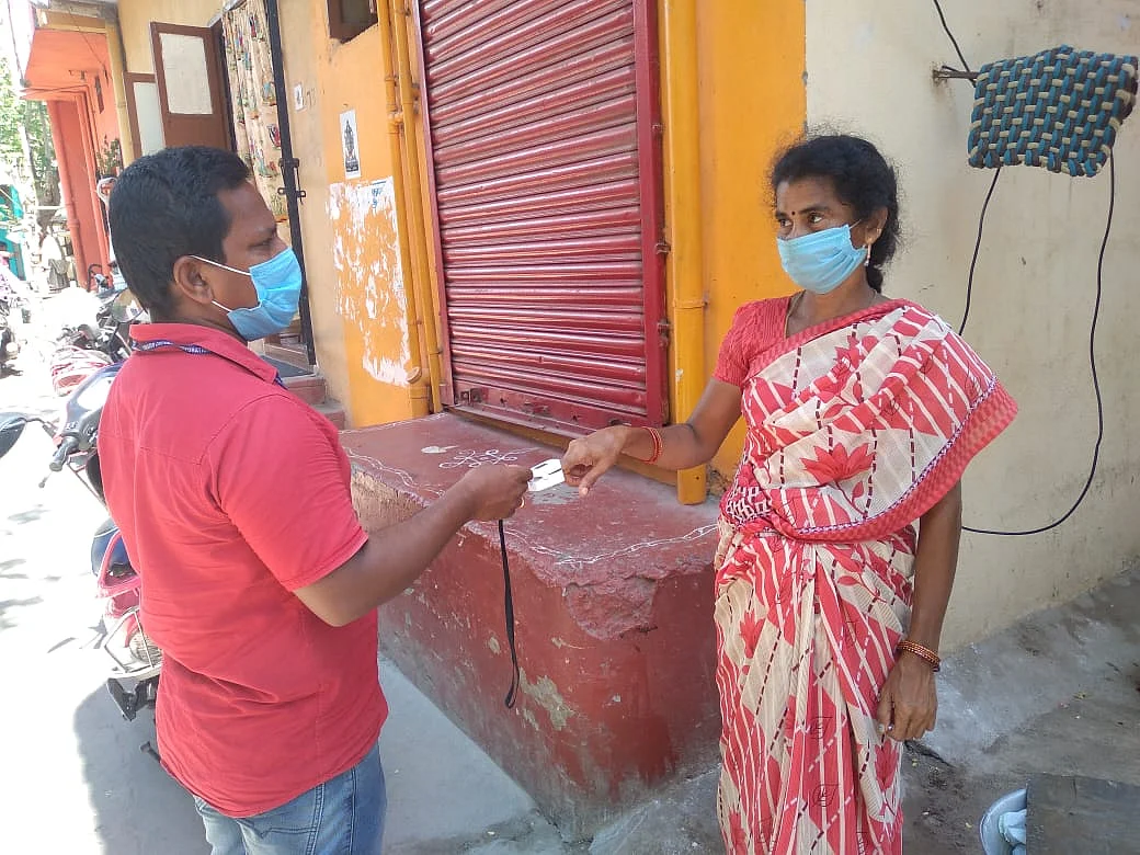 Sripathy D , a surveyor, takes oxygen saturation reading of a resident.