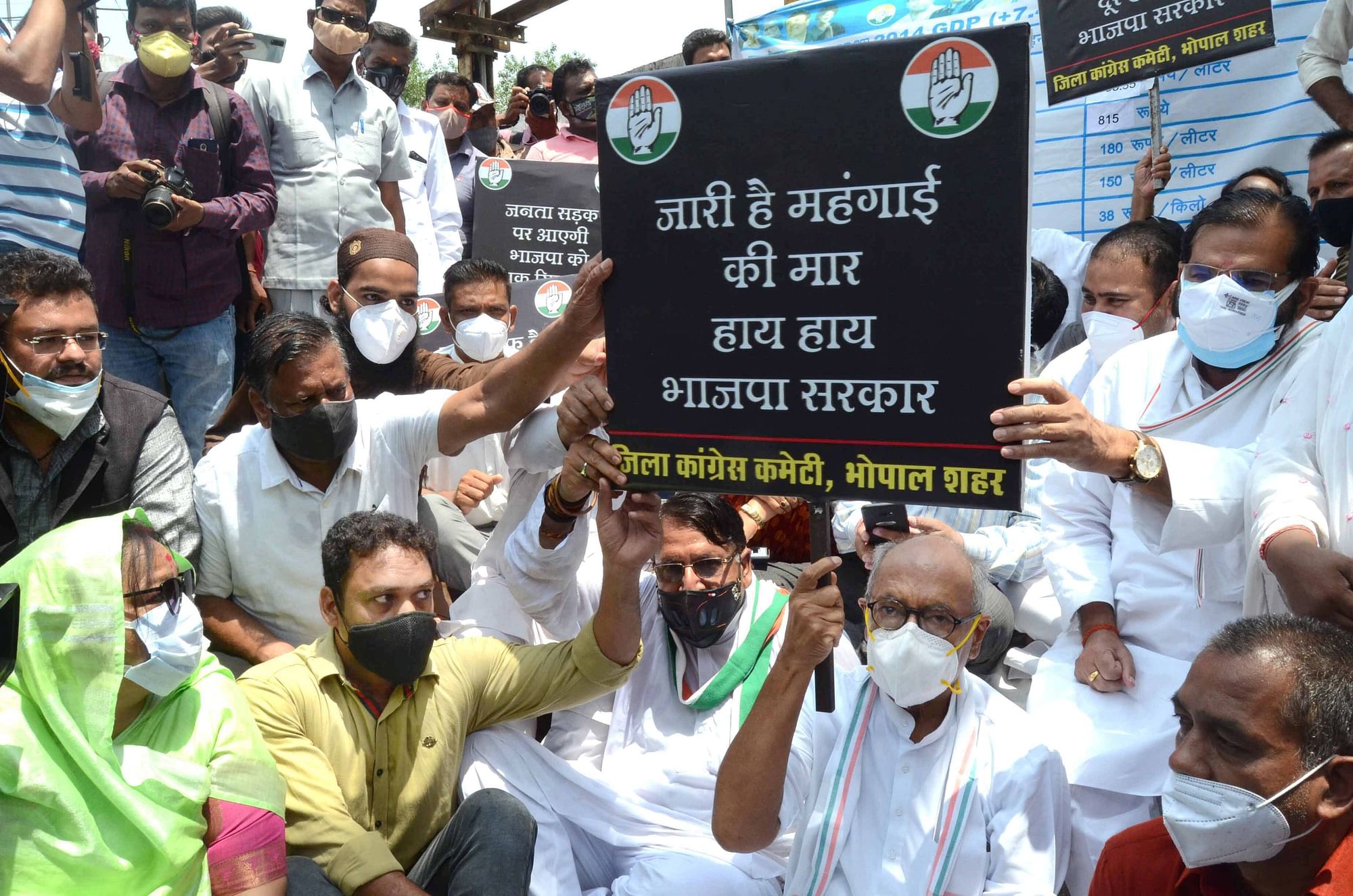 Bhopal: Congress leader and Rajya Sabha MP Digvijay Singh along with activists protest against frequent hikes in the prices of petrol and diesel, and demand the roll back of prices, in front of a fuel station in Bhopal, Friday, June 11, 2021