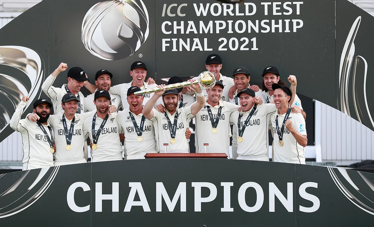 New Zealand players celebrate with the winners trophy after their win in the World Test Championship final cricket match against India, at the Rose Bowl in Southampton.