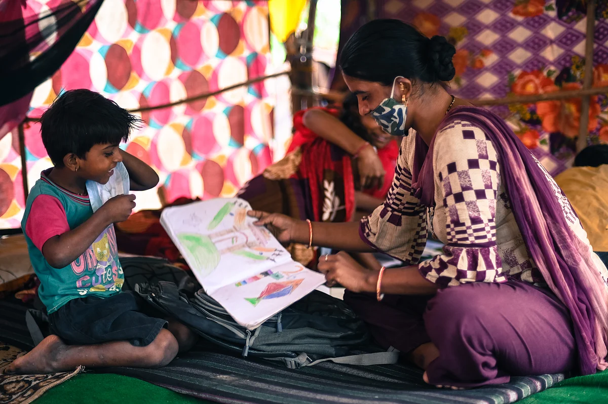 Reshma, 30, plays with her children at the Signature bridge refugee camp in New Delhi. The mother of four children has been concerned about how the lockdowns have affected their education.