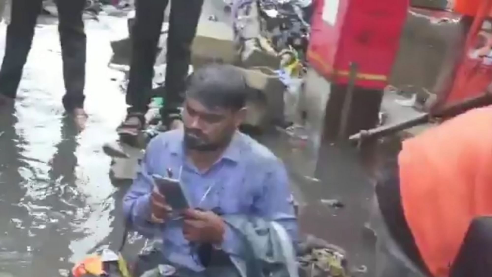 Shiv Sena MLA Dilip Lande on Saturday, forced a BMC contractor to sit on a waterlogged road in Mumbai and asked people to dump garbage on him for not getting drains cleaned properly.