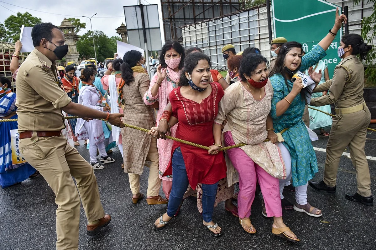 Police personnel try to stop Congress workers protesting against the alleged Ram Mandir Trust land scam, near the CM’s residence in Lucknow.