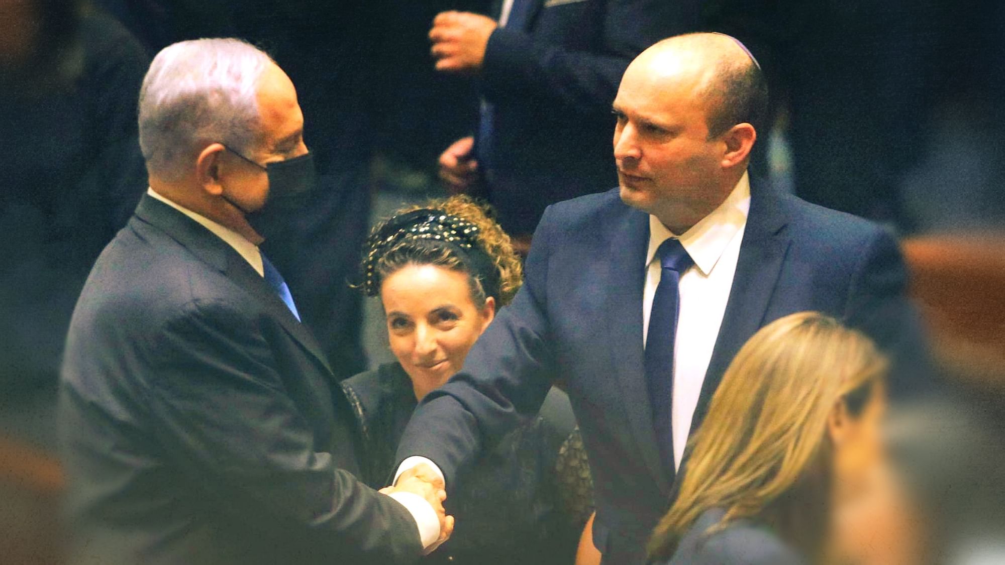 Israel’s new Prime Minister Naftali Bennett greets Benjamin Netanyahu.