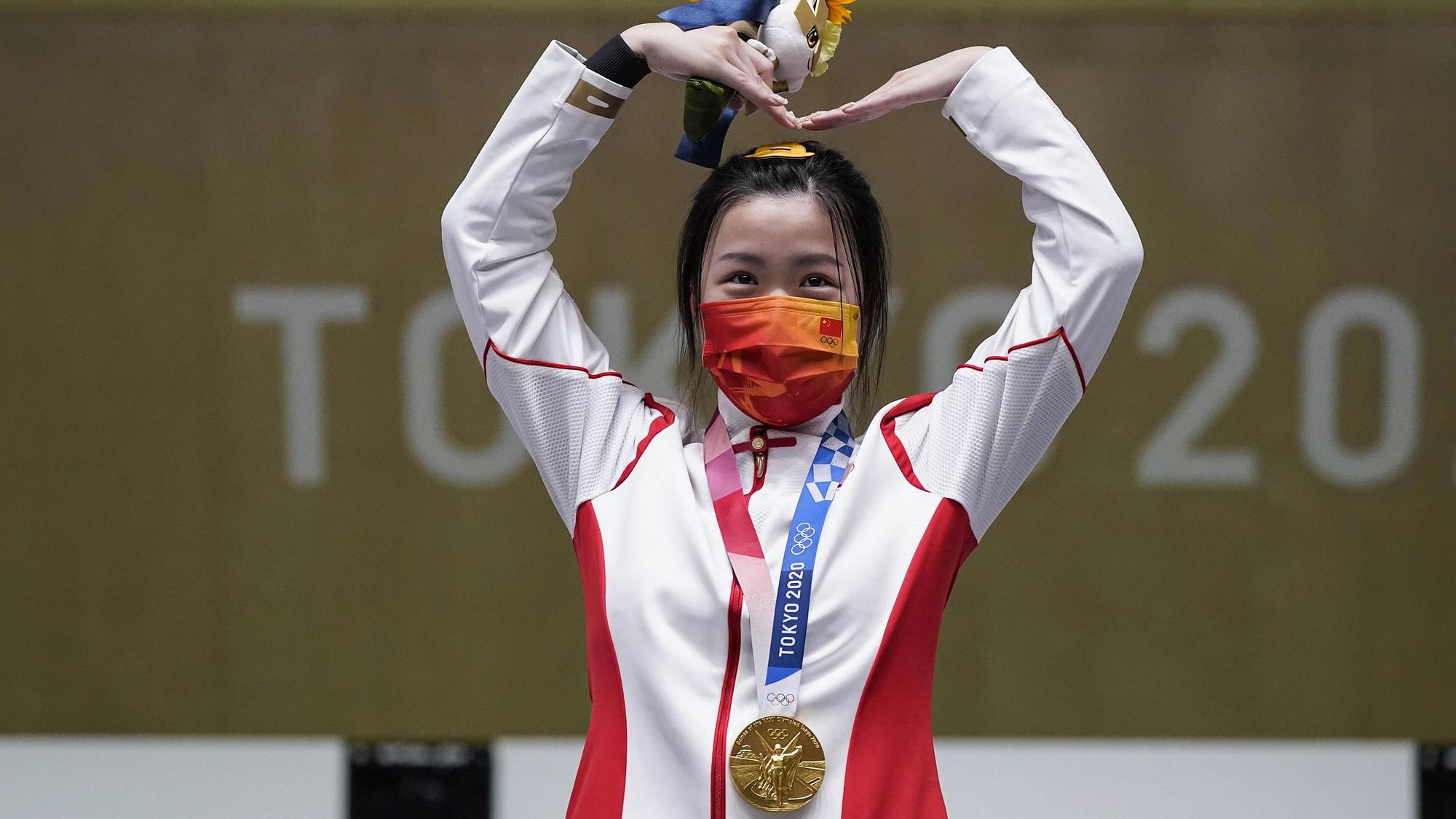 <div class="paragraphs"><p>Qian Yang, of China reacts after winning the gold medal in the women's 10-meter air rifle at the Asaka Shooting Range in the 2020 Summer Olympics.</p></div>
