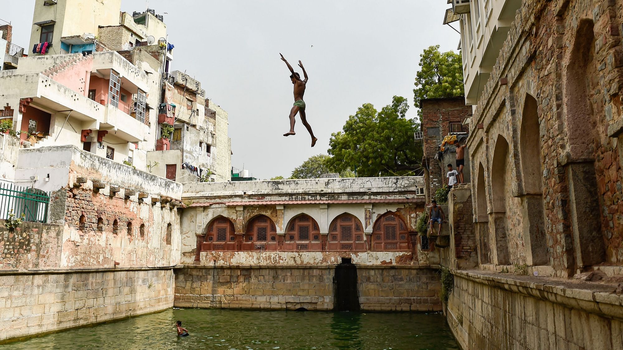 <div class="paragraphs"><p>A boy jumps into a baoli  at Nizamuddin Dargah in New Delhi, on a hot summer day on Friday, 2 July.</p></div>