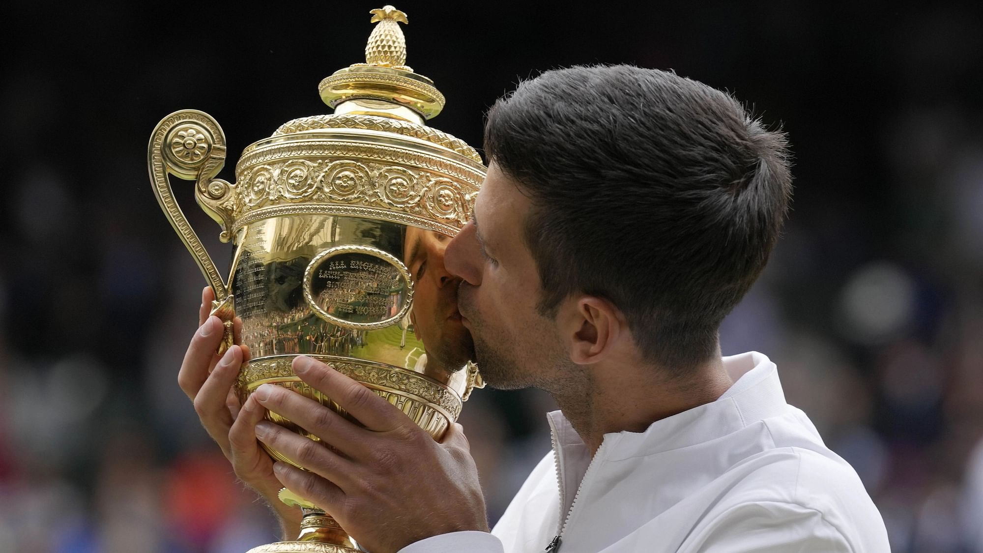 <div class="paragraphs"><p>Serbia's Novak Djokovic kisses the winners trophy as he poses for photographers after he defeated Italy's Matteo Berrettini in the men's singles final on day thirteen of the Wimbledon Tennis Championships in London, Sunday, July 11, 2021.</p></div>
