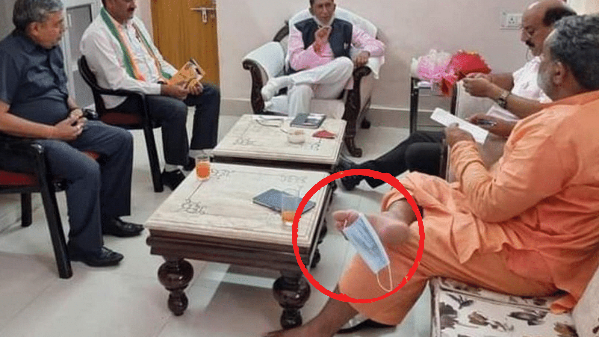 <div class="paragraphs"><p>Swami Yatishwaranand with his mask on his toe.</p></div>