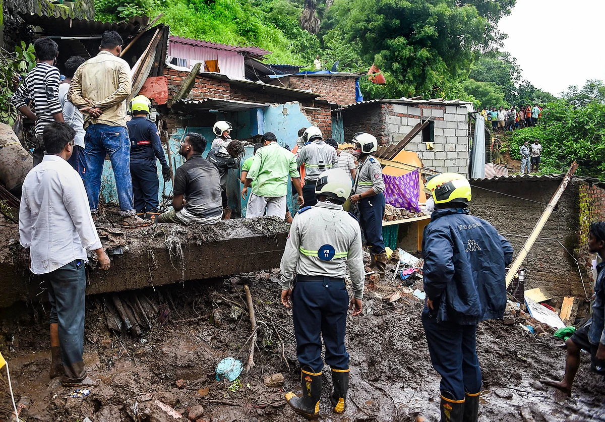 <div class="paragraphs"><p>Firemen and rescue workers after a wall collapsed on some shanties in Chemburs Bharat Nagar area due to a landslide, in Mumbai, Sunday, 18 July.</p></div>