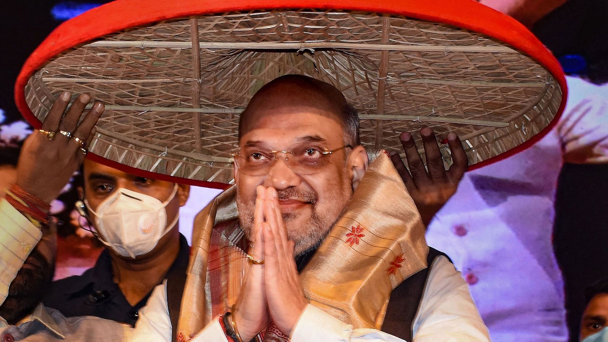 <div class="paragraphs"><p>Union Home Minister Amit Shah being feliciated with traditional Assamese Japi (hat) and Gamocha during his visit to Guwahati, on Sunday, 25 July.</p></div>