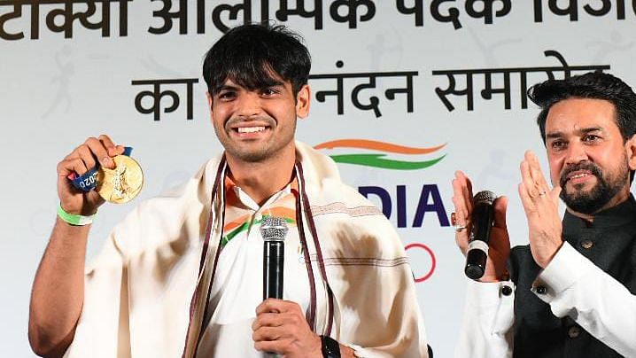 <div class="paragraphs"><p>Neeraj Chopra shows his gold medal at the felicitation ceremony in New Delhi</p></div>