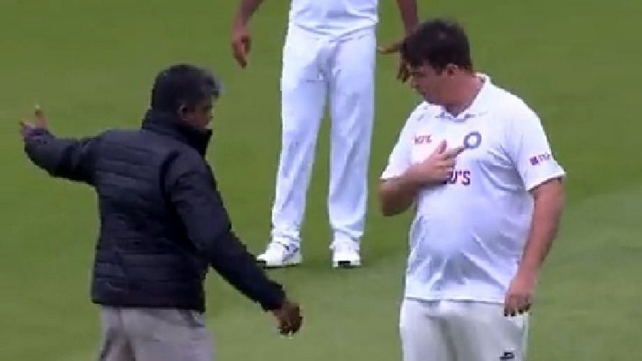 <div class="paragraphs"><p>A spectator dressed in cricket whites and sporting an Indian Test shirt walked out onto the field to join the Indian team after lunch.</p></div>