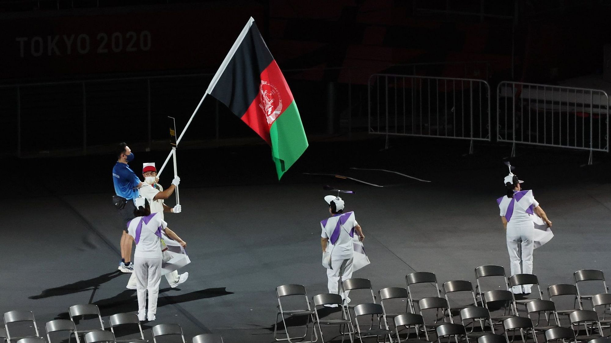 <div class="paragraphs"><p>A Tokyo Paralympics volunteer with Afghanistan's flag at the opening ceremony.</p></div>