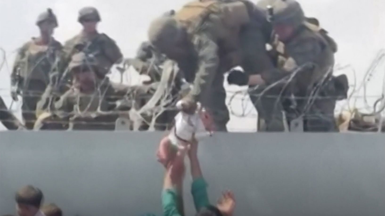 <div class="paragraphs"><p>The video shows a man, presumably a native,  handing over a baby girl to an American soldier guarding the barrier at the Kabul airport.</p></div>