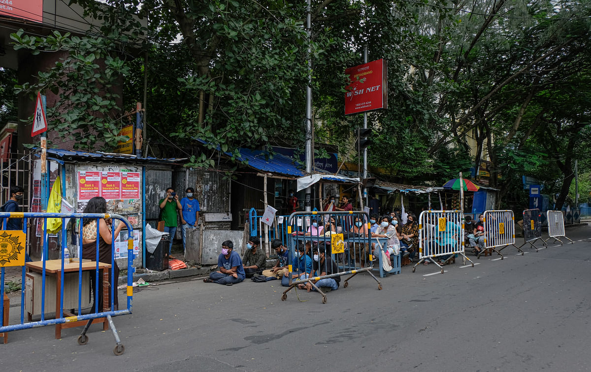 A group of Jadavpur University students are attending offline classes on the road outside the campus.