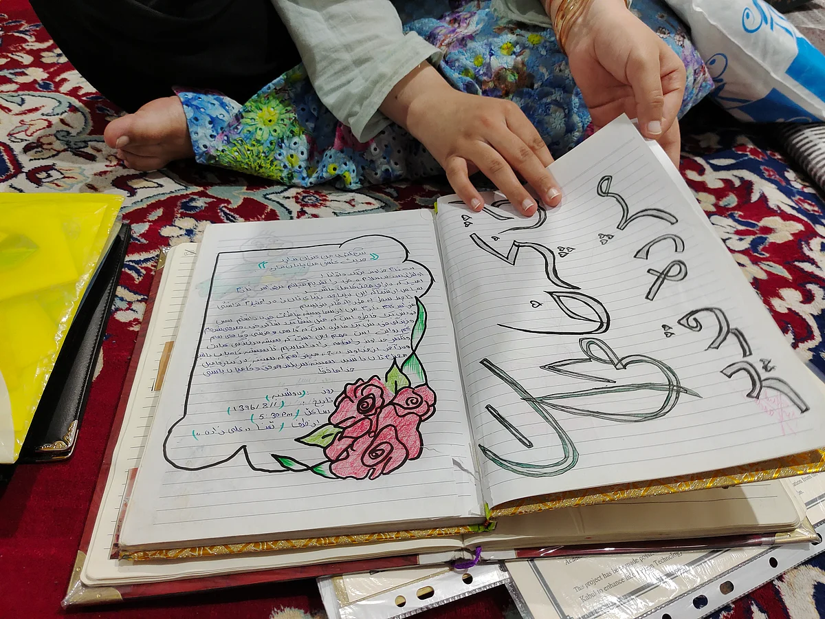 <div class="paragraphs"><p>A notebook, with her friends' messages, was one of the only things Muzhda carried with her from Afghanistan. She says it is precious.</p></div>
