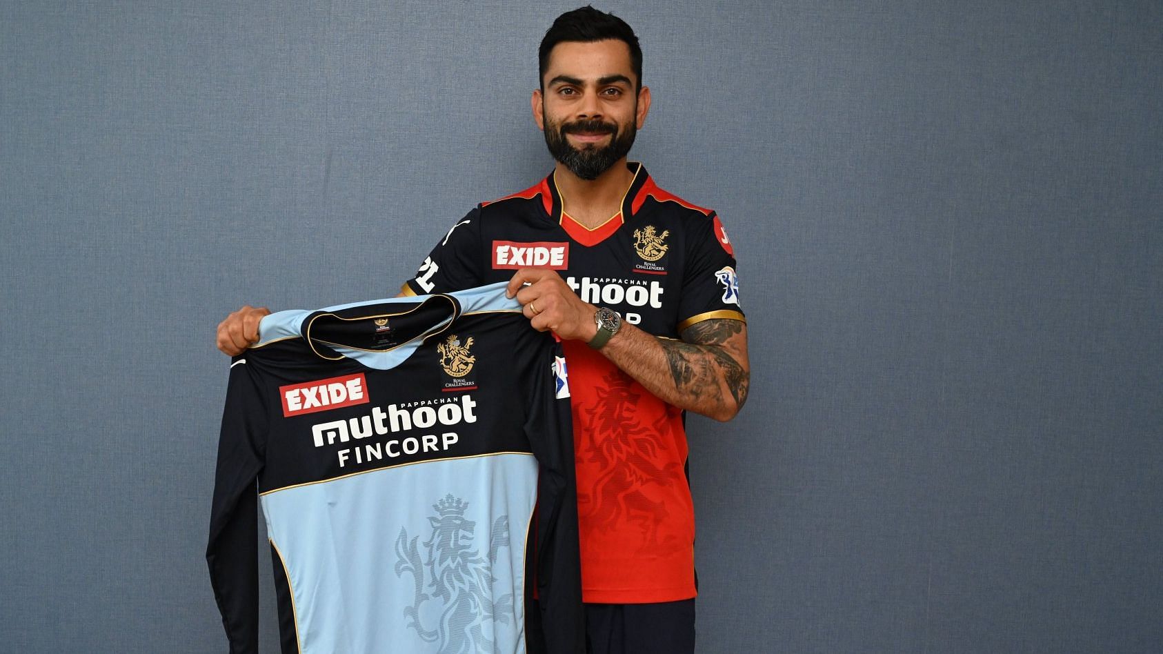 <div class="paragraphs"><p>Virat Kohli poses with the special blue jersey RCB will wear against KKR.&nbsp;</p></div>
