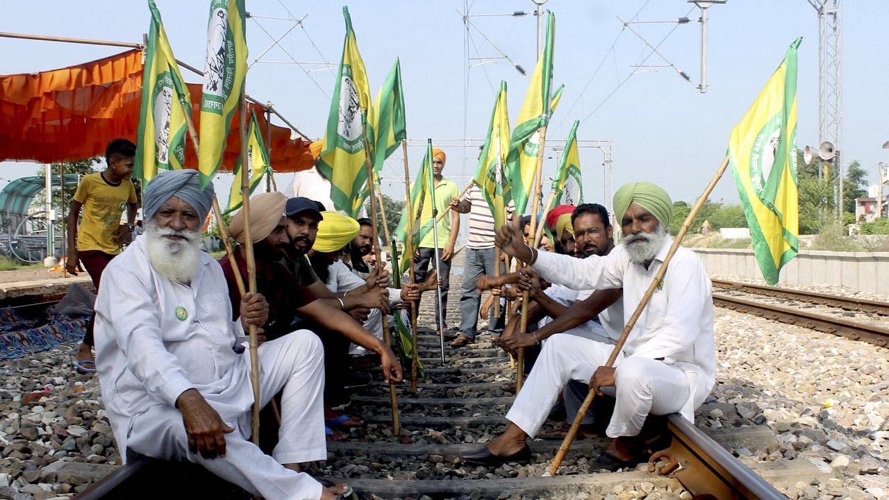 <div class="paragraphs"><p>Members of Bhartiya Kisan Union Ugrahan block the railway tracks during farmers' Bharat Bandh at Dhablaan village near Patiala.</p></div>
