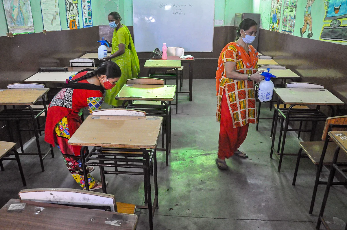 <div class="paragraphs"><p>Workers sanitise a classroom ahead of its reopening for classes 1 to 5, in Moradabad, Tuesday, Aug 31, 2021. UP government has allowed schools to reopen the junior classes too from 1 September.</p></div>