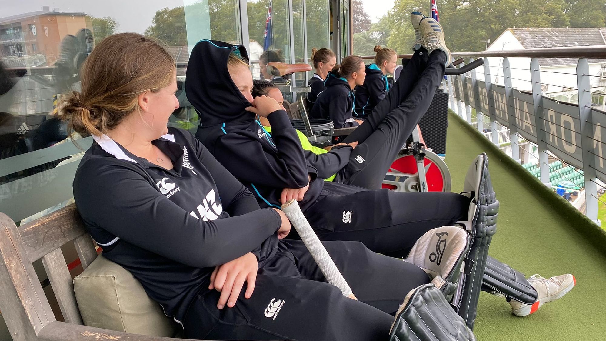 <div class="paragraphs"><p>New Zealand's women's cricket team sitting in their dressing room balcony in England.</p></div>