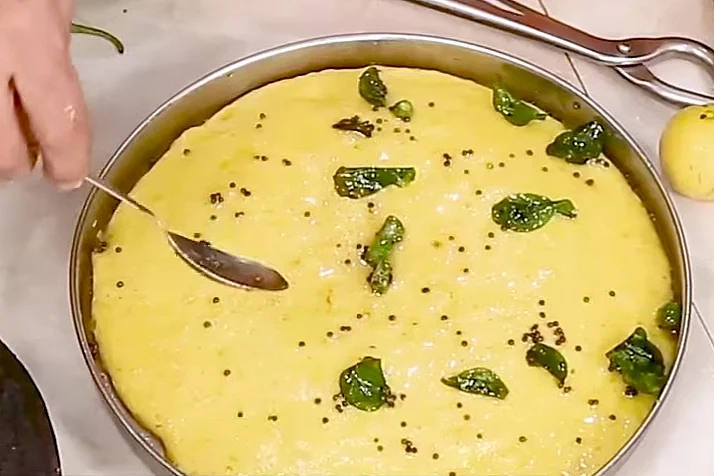 <div class="paragraphs"><p>Pour the tempering mix on the Khaman Dhokla</p></div>