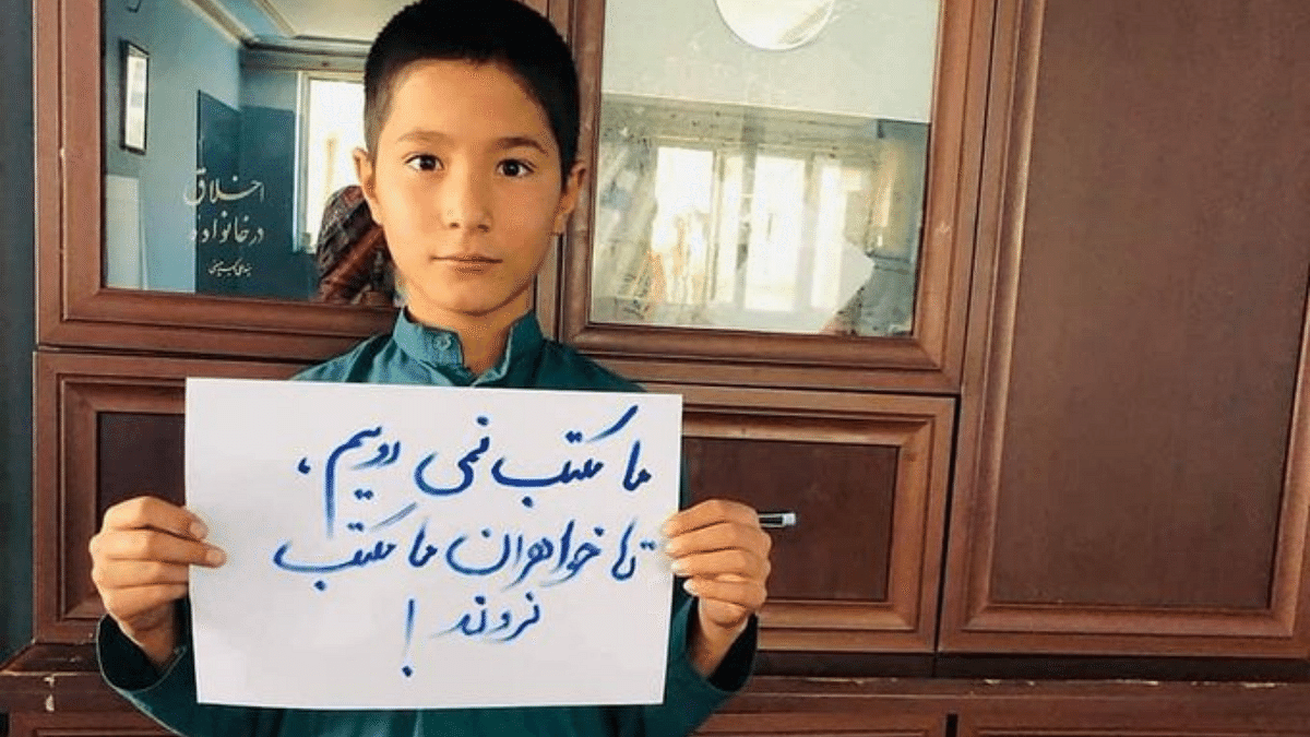 <div class="paragraphs"><p>An Afghan boy holding a placard that reads, "We don't go to school without our sisters."</p></div>