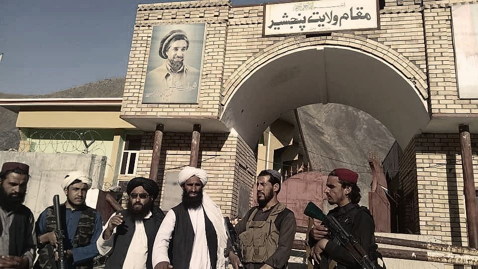 <div class="paragraphs"><p>Taliban fighters have hoisted their flag at the Panjshir Valley, the stronghold of Taliban opponent Ahmad Shah Massoud (portrait on the wall).</p></div>