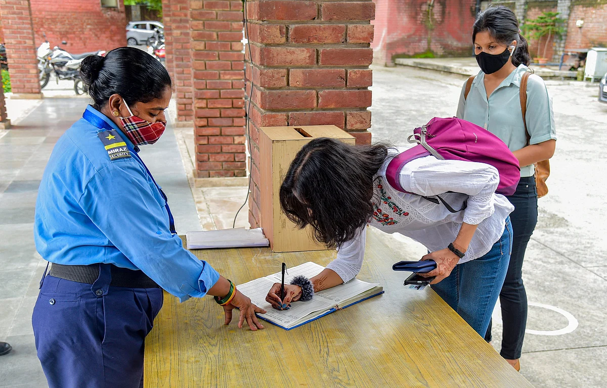 <div class="paragraphs"><p> A student writes her details in a register before entering the Miranda House College after DU colleges reopened for final-year students on Wednesday.</p></div>