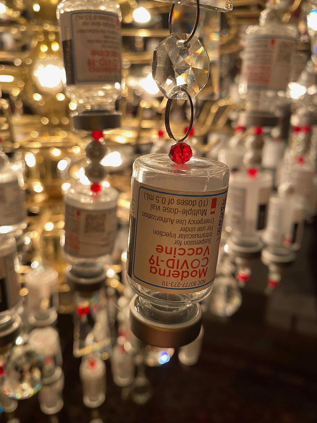 <div class="paragraphs"><p>Empty vaccine vials transformed into a chandelier.</p></div>