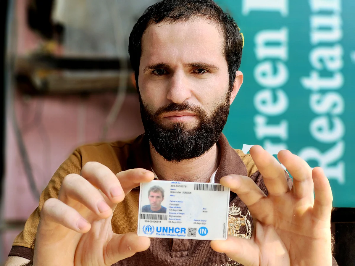 <div class="paragraphs"><p>Sikander Khan (26) shows his refugee card. Several other Afghan refugees in India have not been able to get these cards from the UNHCR. He hopes this card will help him create a better life for his daughter in a country like Canada.</p></div>