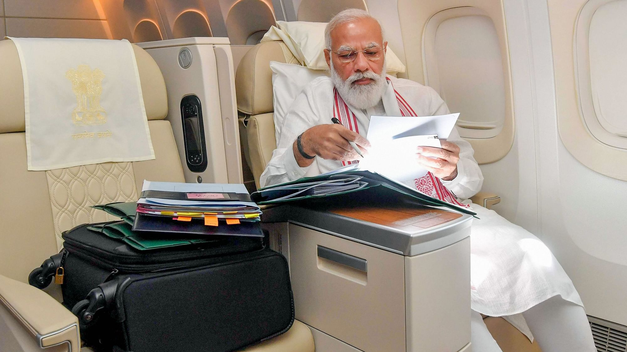 <div class="paragraphs"><p>Prime Minister Narendra Modi works on Air India while travelling to the US on Wednesday, 22 September.</p></div>