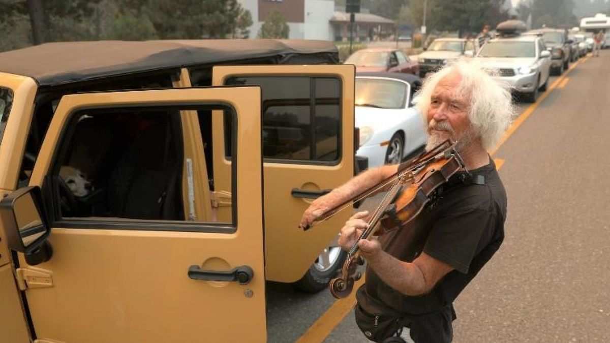 Watch: Man Plays Violin In Traffic While Californians Escape Wildfire
