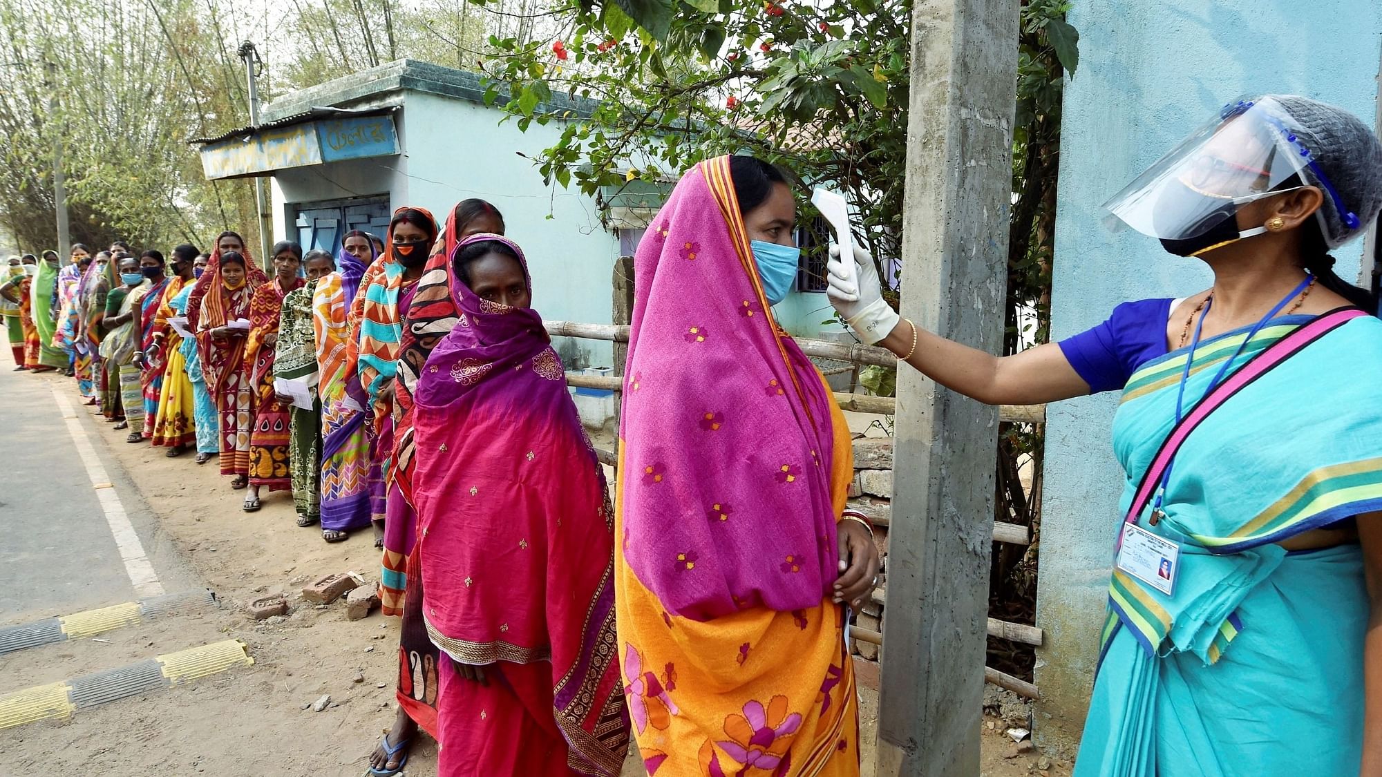<div class="paragraphs"><p>File photo of voters undergoing thermal scanning, as precaution against COVID-19, while waiting to cast votes at a polling station, during the first phase of West Bengal Assembly elections, at Sirshi in Jhargram. Image used for representation only.</p></div>