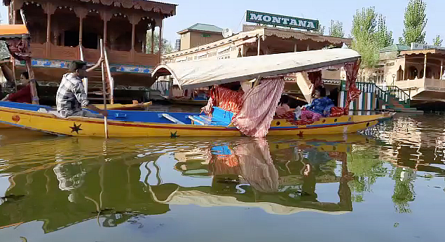 <div class="paragraphs"><p>Tourists taking ride on a Shikara on Dal Lake</p></div>
