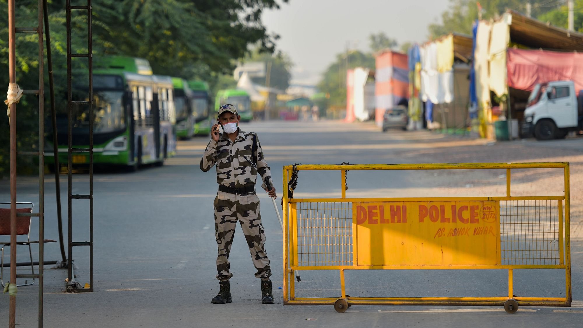 <div class="paragraphs"><p>New Delhi: A security person keeps vigil at Singhu Border near the site of the farmers' protest on Friday. </p></div>