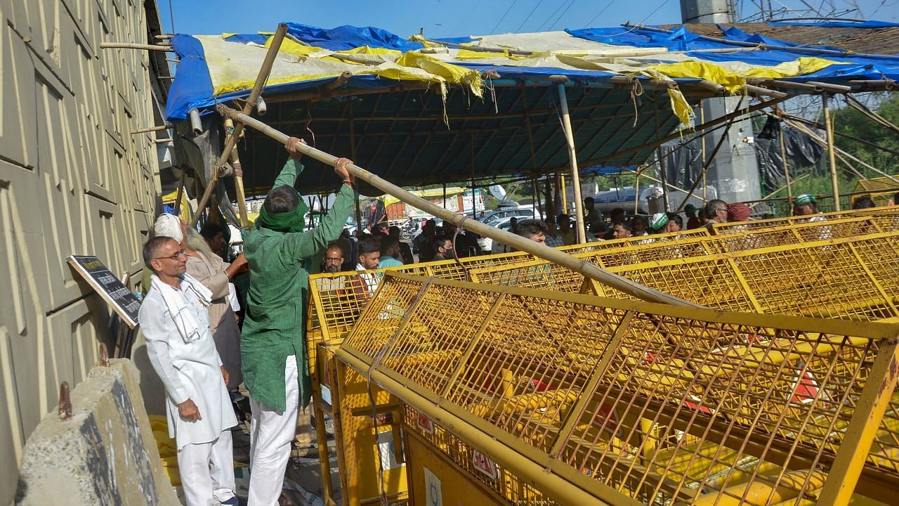 <div class="paragraphs"><p>Farmers remove barricades from a road leading to Delhi near Ghazipur border picket site after the orders of the Supreme Court in Ghaziabad.</p></div>