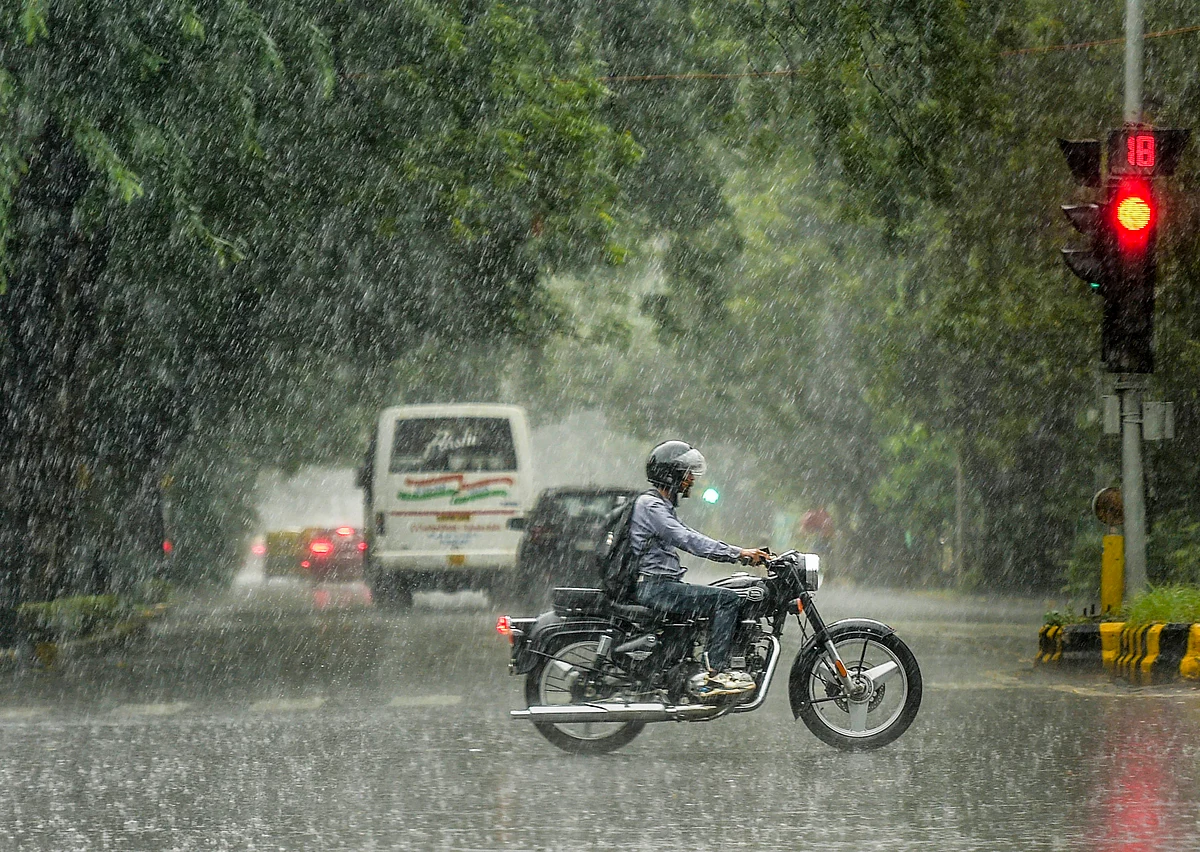 <div class="paragraphs"><p>A motorcyclist rides through heavy rain in New Delhi on Sunday, 17 October.</p></div>