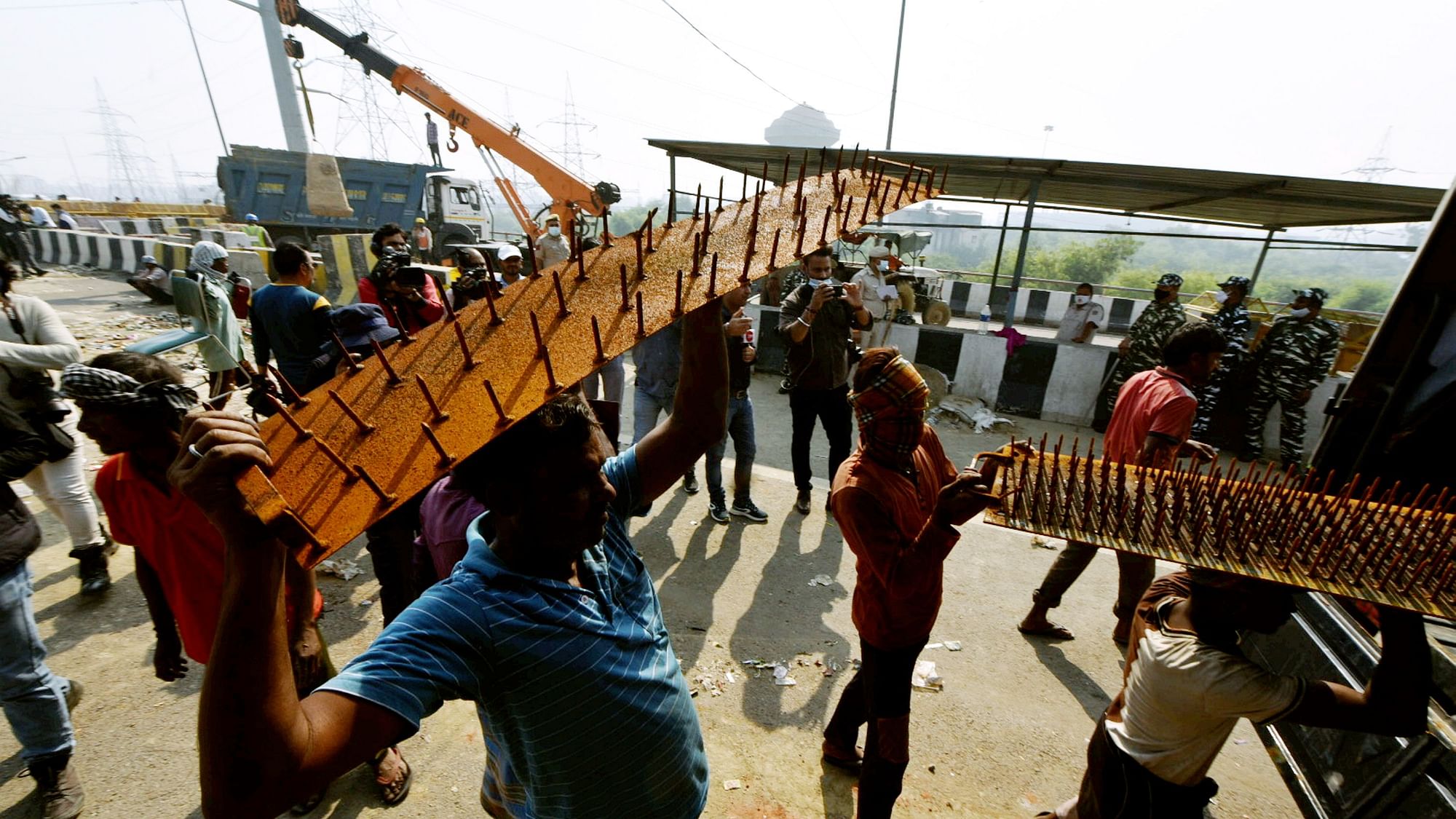 <div class="paragraphs"><p>Police barricades being removed from the farmers' protest site at Ghazipur border on Friday, 29 October.</p></div>