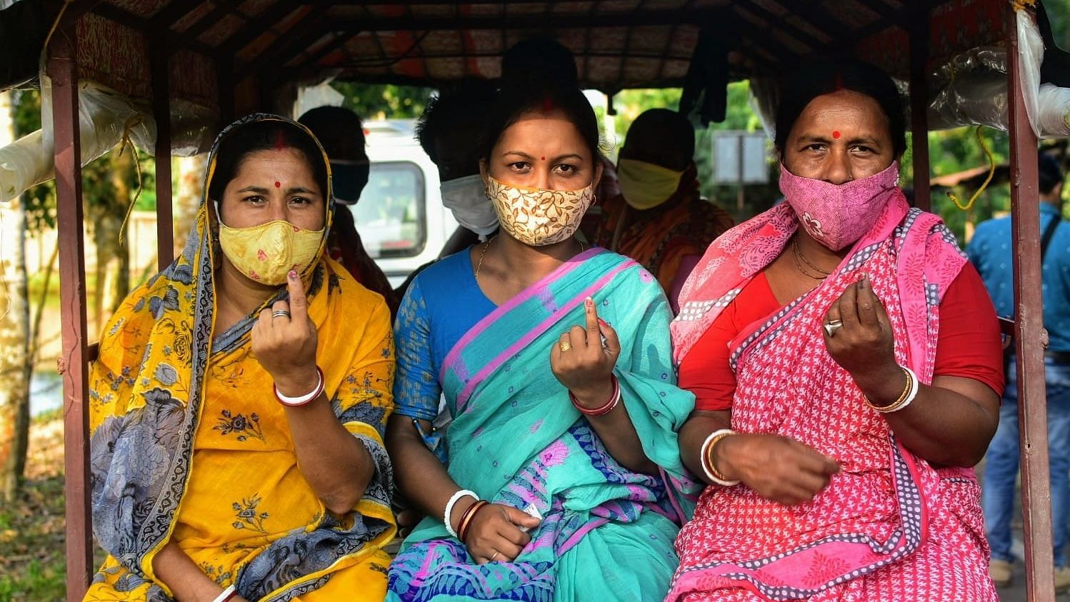 <div class="paragraphs"><p>Voters showcasing their inked-fingers after casting their vote under 127 Gosaba (SC) Assembly Constituency of South 24 Parganas District.</p></div>