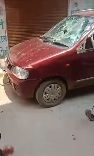 <div class="paragraphs"><p>The red hatchback, being damaged.</p></div>