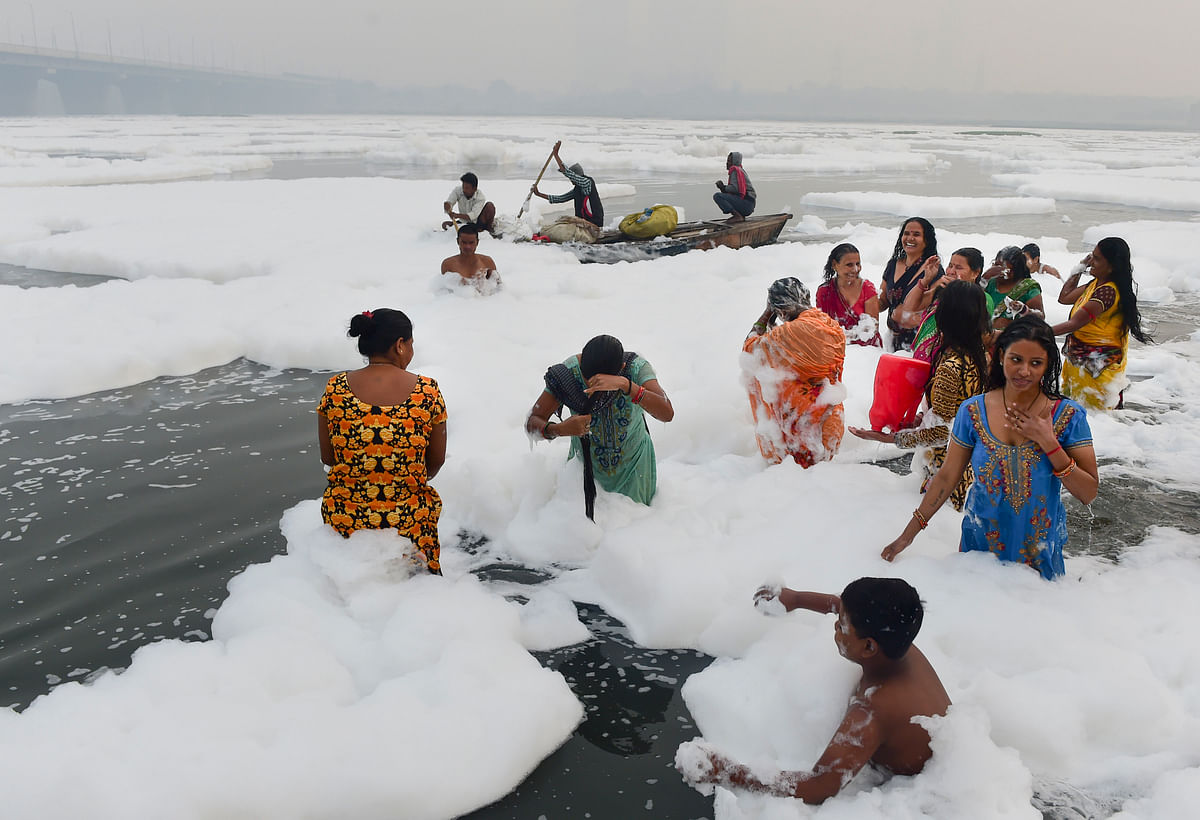 <div class="paragraphs"><p>New Delhi: Hindu devotees offer prayers as part of the rituals of four-day long Chhath Puja celebrations, as toxic foam floats on the surface of polluted Yamuna river at Kalindi Kunj, in New Delhi on Monday.</p></div>
