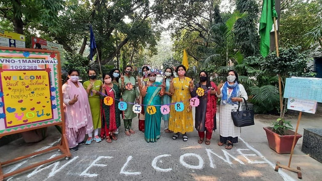 <div class="paragraphs"><p>Teachers welcoming primary students to school in New Delhi, 1 November.</p></div>
