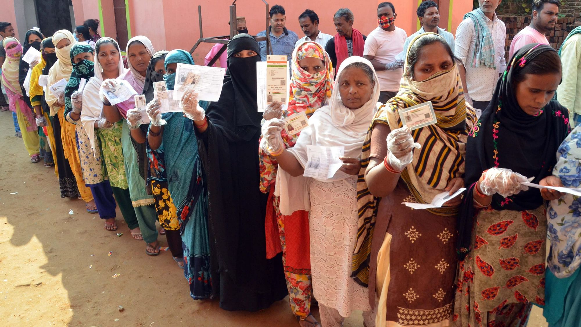 <div class="paragraphs"><p>Voters show their identity cards before casting votes at a polling station, during Tarapur assembly bypolls, in Munger district, on Saturday, 30 October.</p></div>