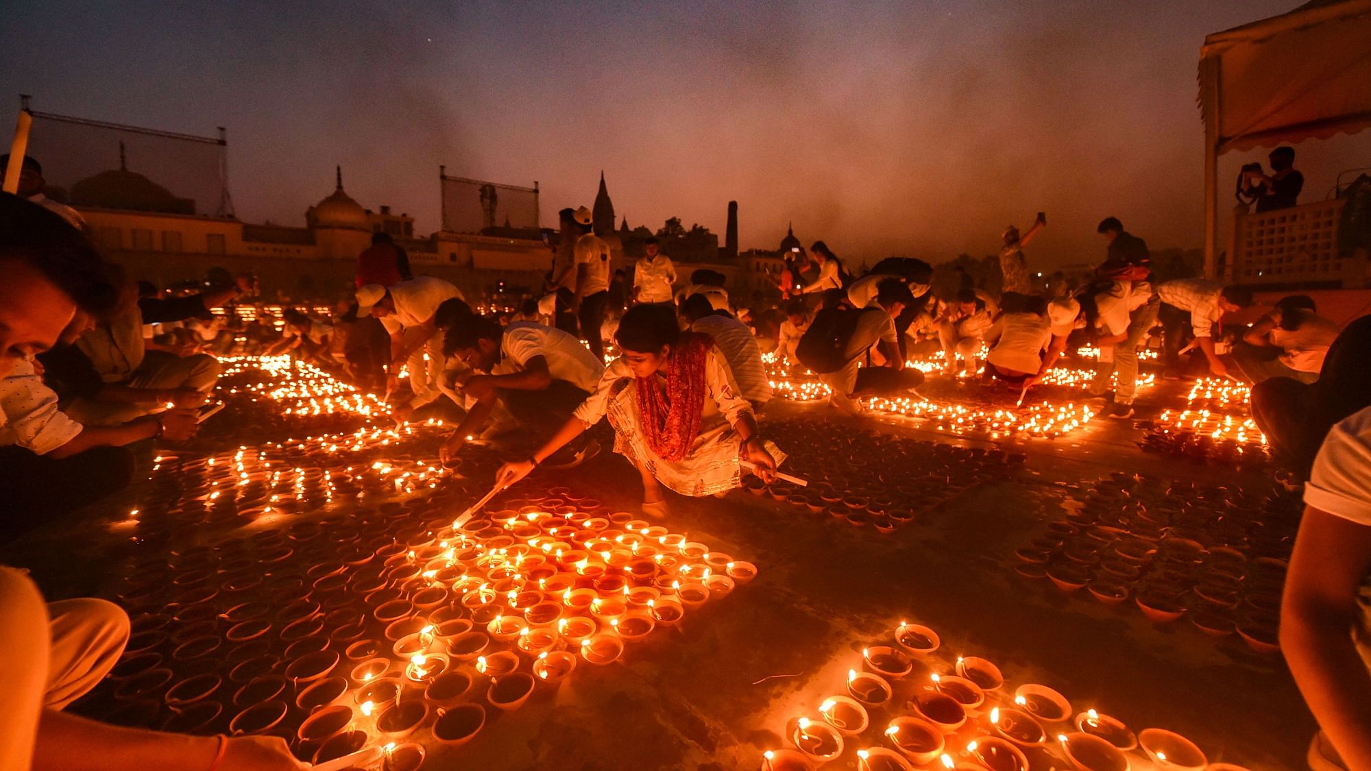 <div class="paragraphs"><p>Ayodhya: Devotees light earthen lamps on the bank of Saryu River during Deepotsav celebrations, on 3 November.</p></div>