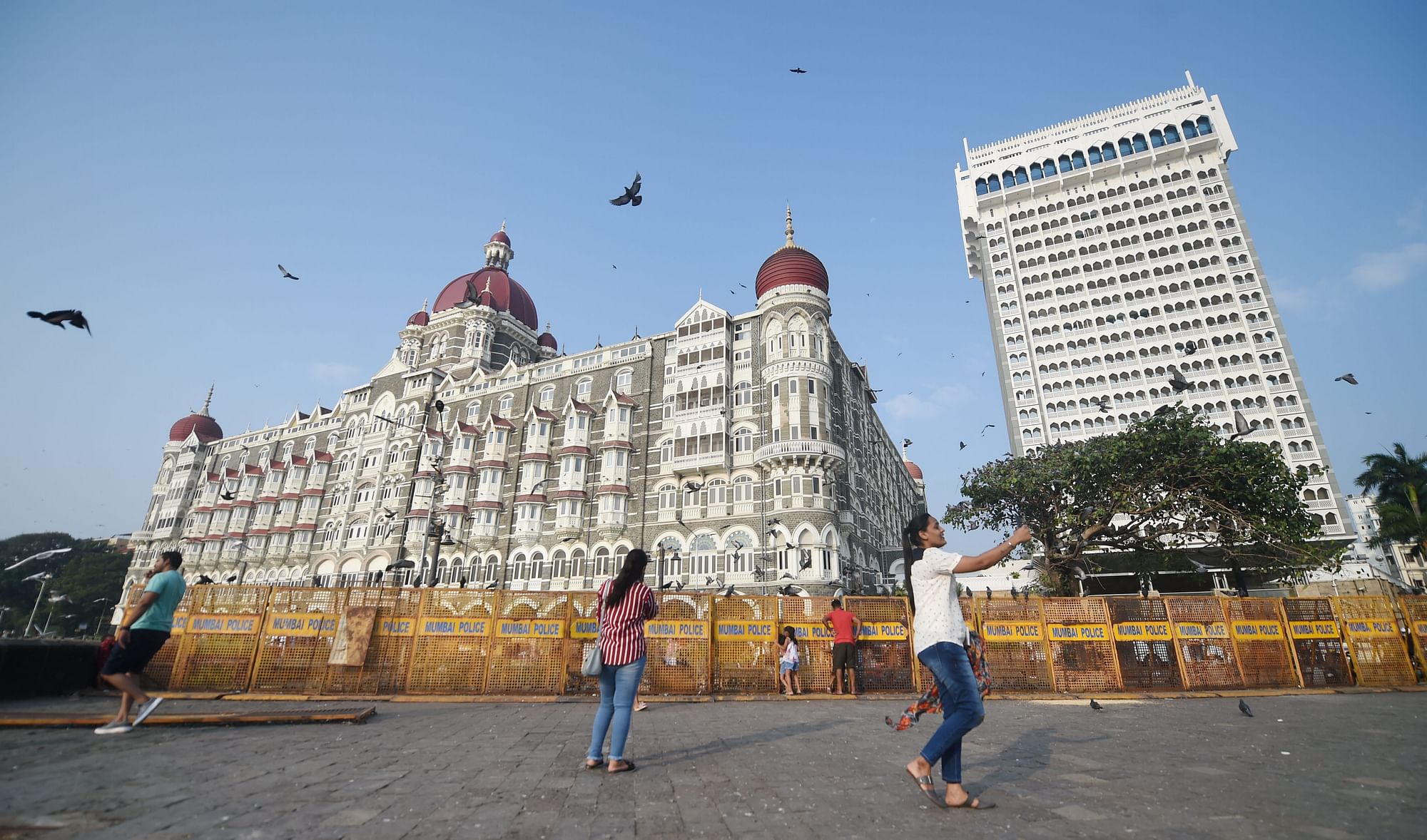 <div class="paragraphs"><p>Tourists outside the Taj Mahal Palace hotel , one of the sites of the 2008 Mumbai terror attacks that had claimed 166 lives, on the eve of 13th anniversary of the gruesome incident, in Mumbai, Thursday, 25 November. </p></div>