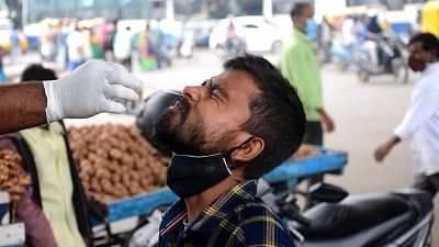 <div class="paragraphs"><p>Bengaluru: A health worker collects a nasal sample from a man for COVID-19 testing at KR Market in Bengaluru on Thursday, 2 December. Image used for representation only.</p></div>