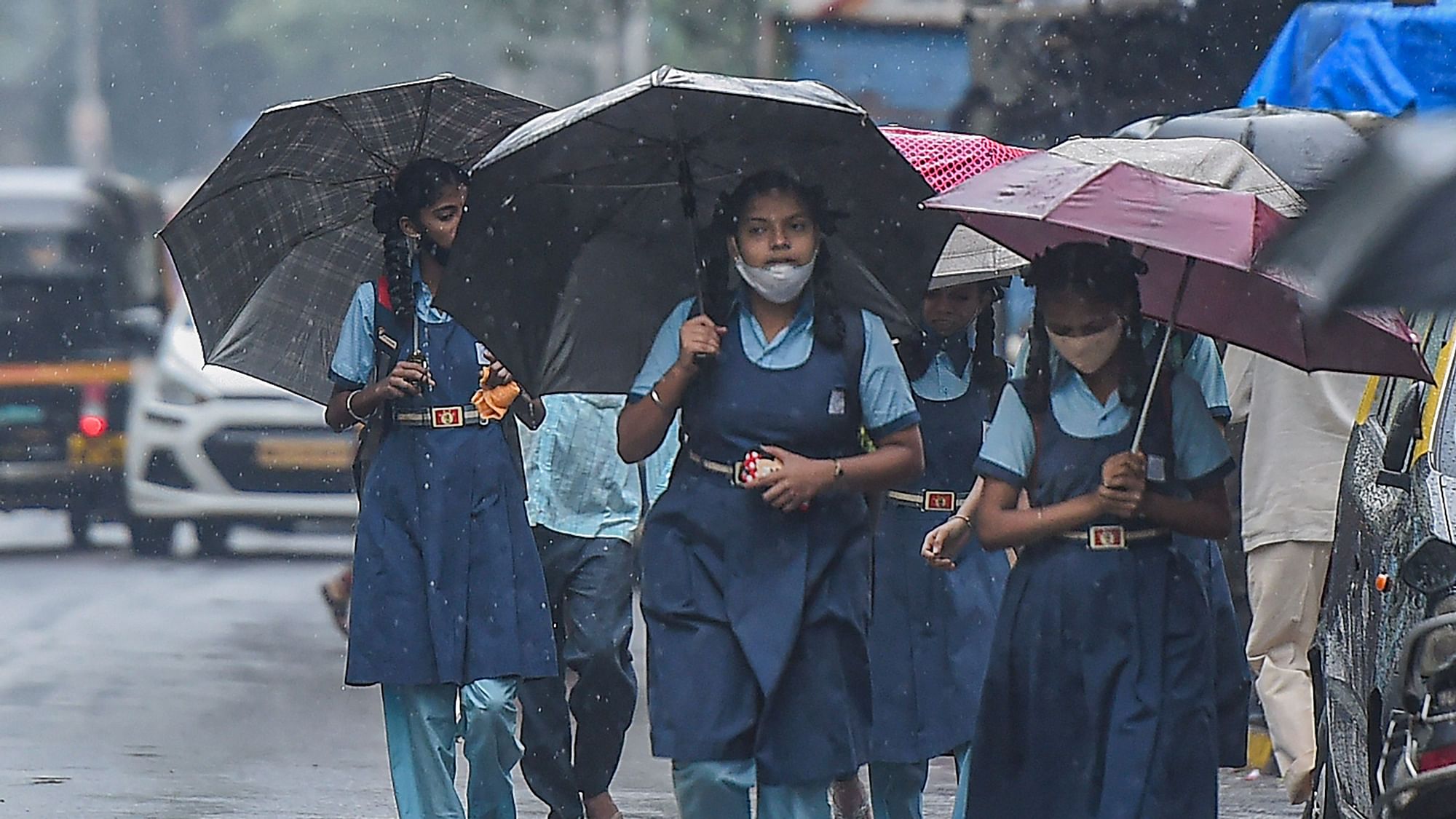 <div class="paragraphs"><p>School children holding umbrellas walk along a road in rain at Sion, in Mumbai. Image used for representational purposes.&nbsp;</p></div>