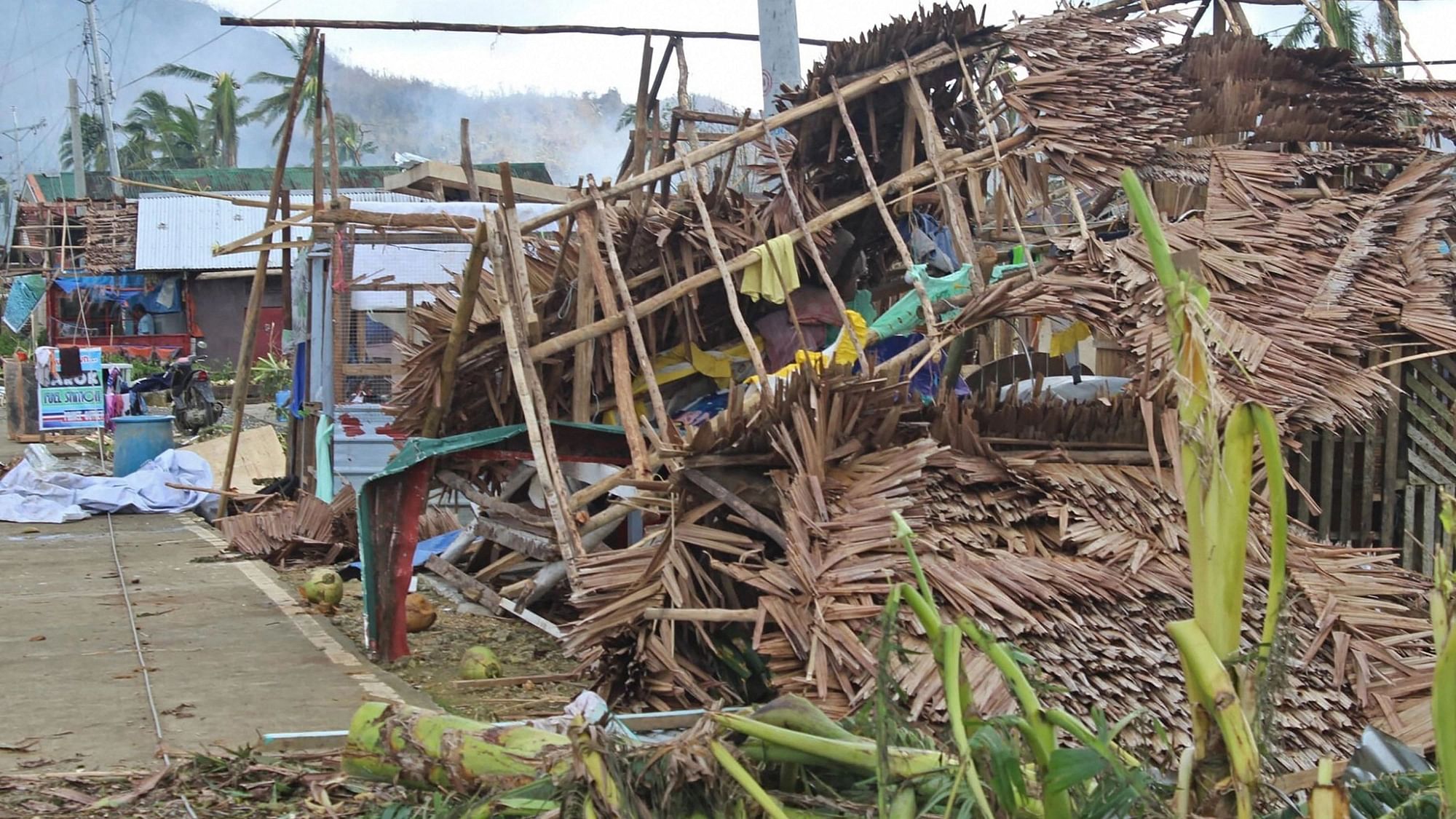 <div class="paragraphs"><p>In this photo provided by the Philippine Coast Guard, a house damaged by Typhoon Rai lies along a road in Surigao del Norte province, southern Philippines on Saturday, 18 December, 2021. </p></div>