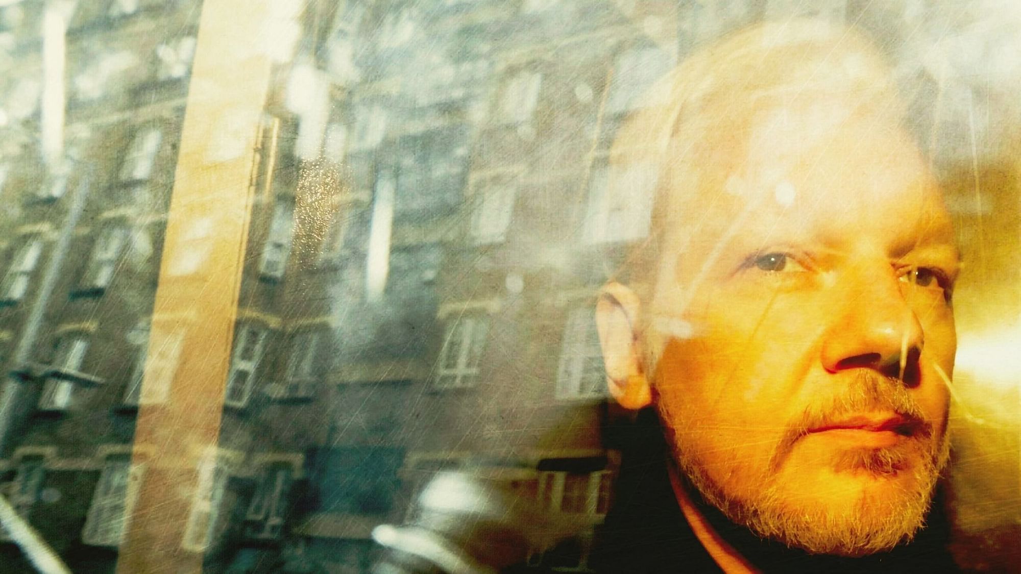 <div class="paragraphs"><p> In this 2019 file photo, buildings are reflected in the window as WikiLeaks founder Julian Assange is taken from court.</p></div>