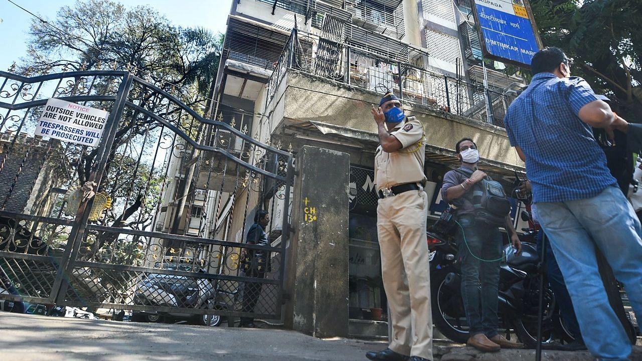 <div class="paragraphs"><p>Police stand guard at Gardan Hall building during a raid by the ED.</p></div>